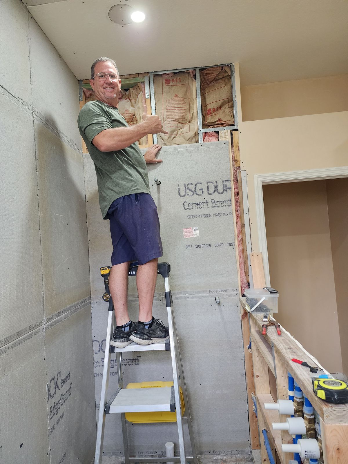 M&M Builds crew installing shower backer board
